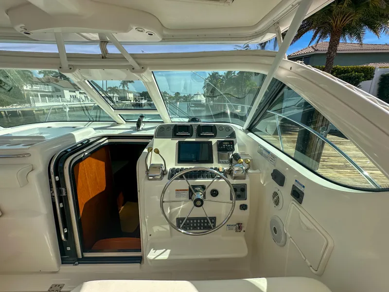 Slide: The Image of 2006 Tiara Yachts 3200 Open helm with steering wheel and navigation controls. - 31