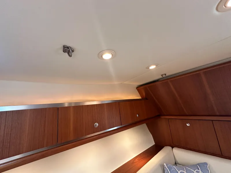 Slide: The Image of Interior of 2006 Tiara Yachts 3200 Open, featuring wooden cabinetry and recessed lighting. - 44