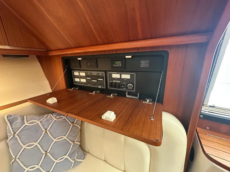 Slide: The Image of 2006 Tiara Yachts 3200 Open cabin with control panel and cushioned seating. - 45