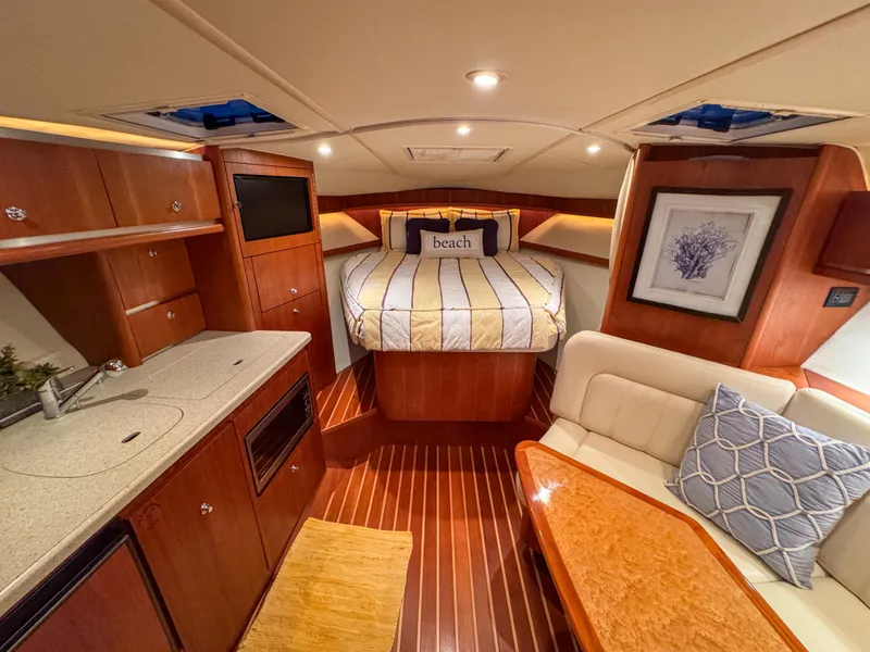 Slide: The Image of Luxurious 2006 Tiara Yachts 3200 Open cabin with cozy bed and elegant wood finishes. - 46