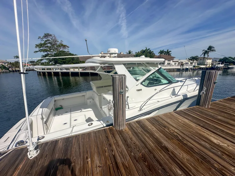 Slide: The Image of 2006 Tiara Yachts 3200 Open docked by a wooden pier under a clear sky. - 5