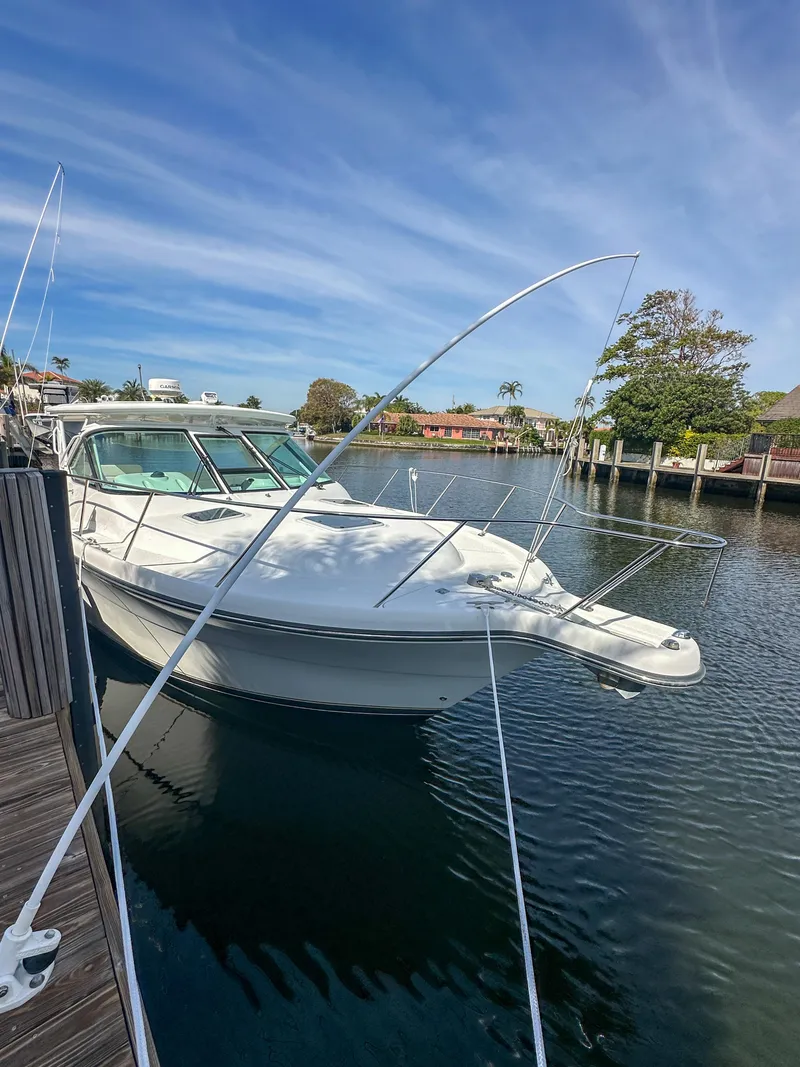 Slide: The Image of 2006 Tiara Yachts 3200 Open docked in a serene marina setting. - 6