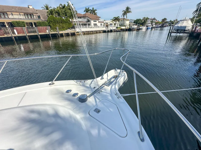 Slide: The Image of 2006 Tiara Yachts 3200 Open on a serene canal with waterfront homes. - 8