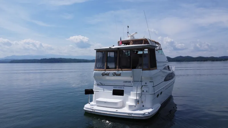 Slide: The Image of 2002 Carver 466 Motor Yacht on calm water under a clear sky. - 10