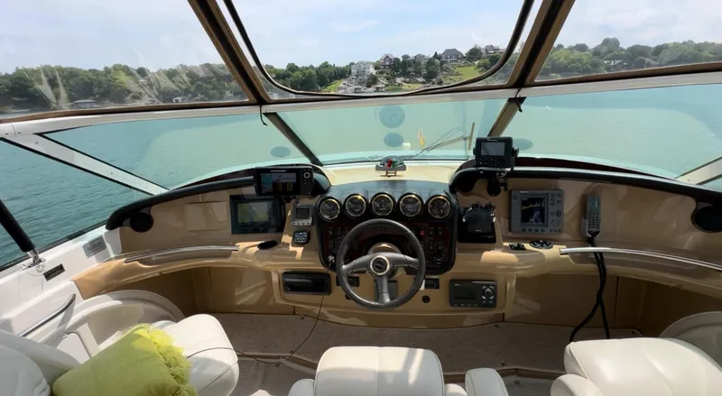 Slide: The Image of 2002 Carver 466 Motor Yacht helm with panoramic water view and navigation instruments. - 11