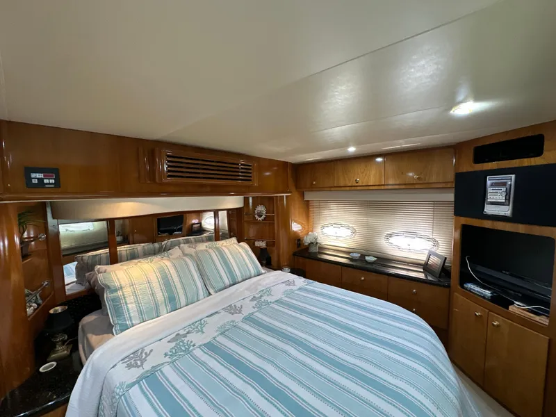 Slide: The Image of Luxurious bedroom interior of 2002 Carver 466 Motor Yacht with elegant wood finishes. - 23