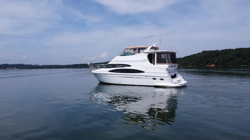 Slide: The Image of 2002 Carver 466 Motor Yacht on calm water under a clear sky. - 28