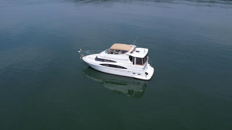 Slide: The Image of 2002 Carver 466 Motor Yacht on calm water, aerial view. - 6