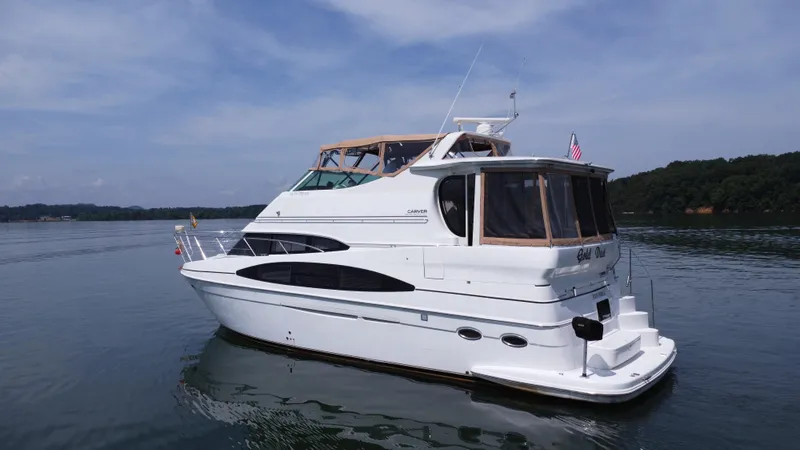 Slide: The Image of 2002 Carver 466 Motor Yacht on calm water under a clear sky. - 9