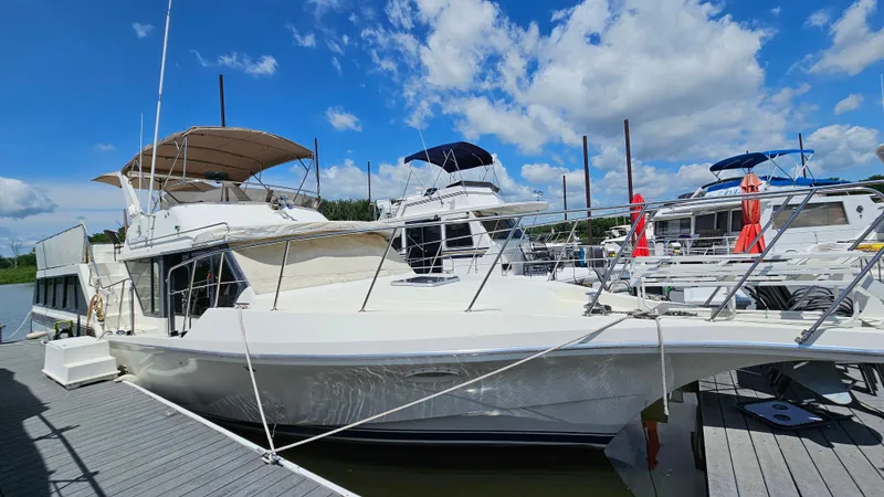 The Image of 1988 Bluewater Yachts 55 Coastal Cruiser docked under a clear blue sky. - 1