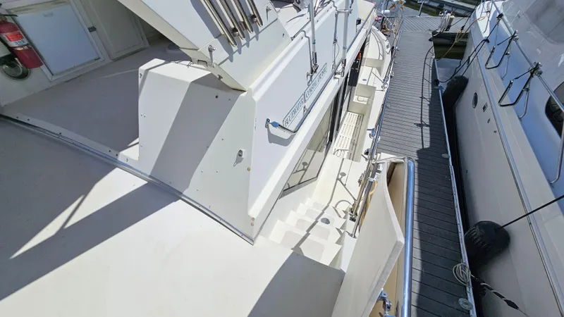 Slide: The Image of 1988 Bluewater Yachts 55 Coastal Cruiser docked, showcasing deck and exterior details. - 12