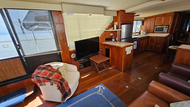 Slide: The Image of Luxurious interior of 1988 Bluewater Yachts 55 Coastal Cruiser with modern kitchen and cozy seating. - 15