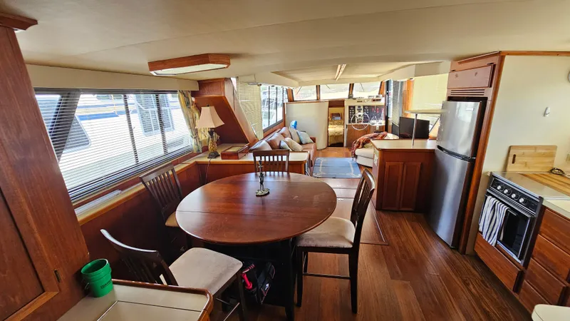 Slide: The Image of Interior of 1988 Bluewater Yachts 55 Coastal Cruiser with dining area and kitchen. - 16