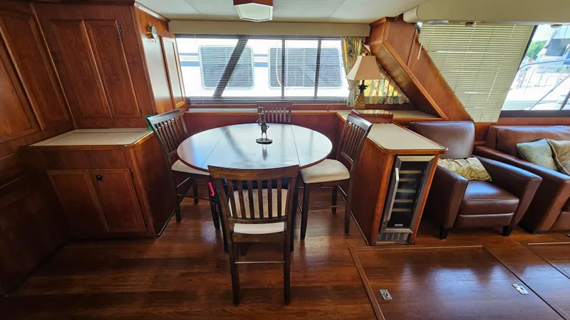 Slide: The Image of Interior of 1988 Bluewater Yachts 55 Coastal Cruiser with dining area and wooden furnishings. - 17