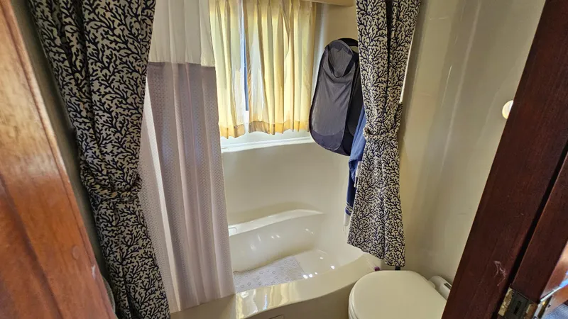 Slide: The Image of Bathroom interior of 1988 Bluewater Yachts 55 Coastal Cruiser with curtains and bathtub. - 24