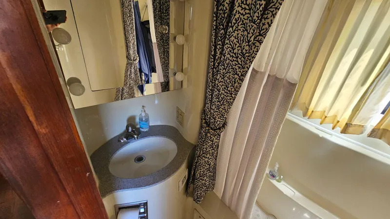Slide: The Image of Bathroom interior of 1988 Bluewater Yachts 55 Coastal Cruiser with sink and shower curtain. - 25