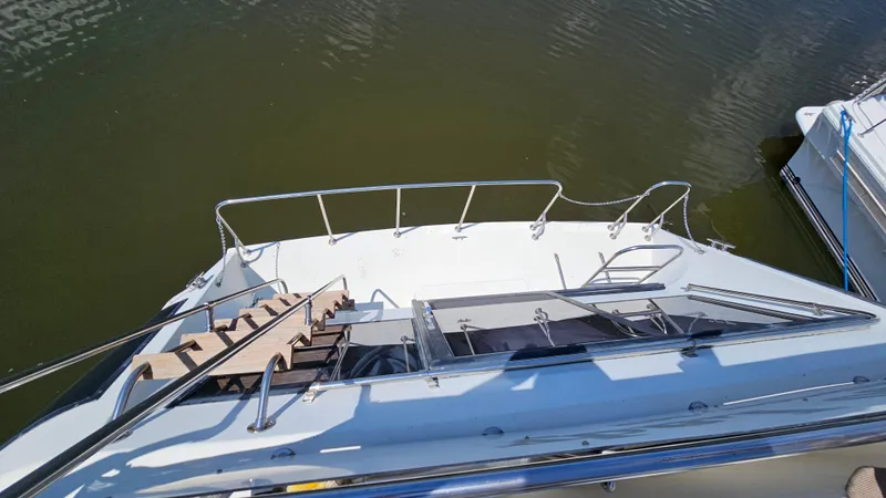 Slide: The Image of 1988 Bluewater Yachts 55 Coastal Cruiser deck view with railing and stairs. - 3