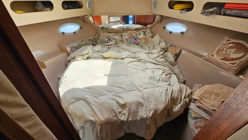 Slide: The Image of Cozy bedroom interior of 1988 Bluewater Yachts 55 Coastal Cruiser with porthole windows. - 30