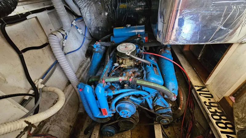 Slide: The Image of Engine room of 1988 Bluewater Yachts 55 Coastal Cruiser with blue engine components. - 33