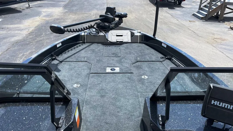 Slide: The Image of 2025 Skeeter WXR 2060 boat interior with carpeted deck and trolling motor. - 2