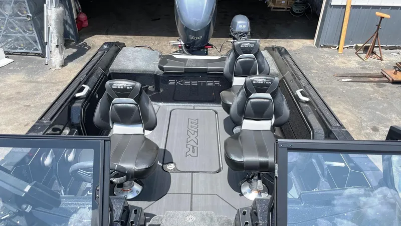 Slide: The Image of 2025 Skeeter WXR 2060 boat interior with black seating and motor. - 5