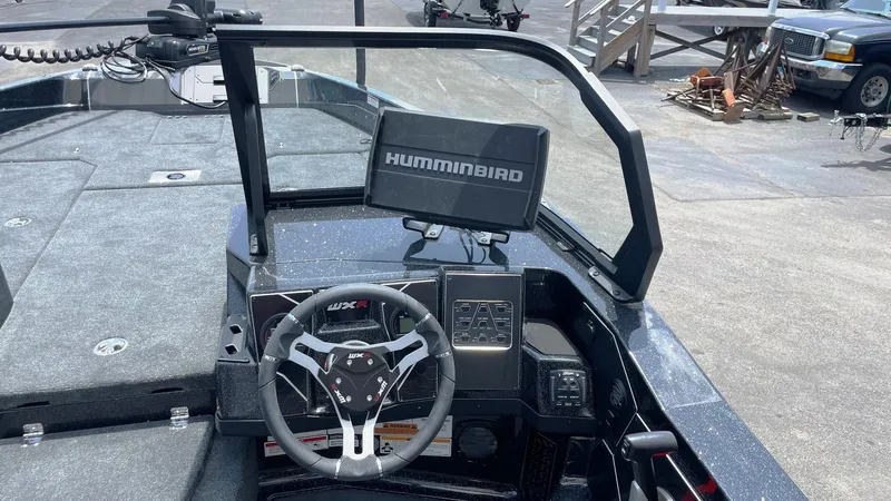 Slide: The Image of 2025 Skeeter WXR 2060 boat dashboard with Humminbird navigation system and steering wheel. - 6