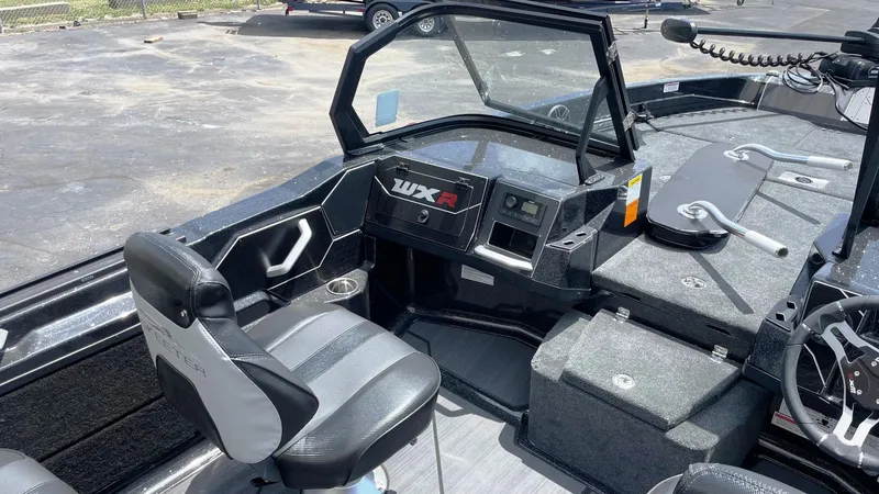 Slide: The Image of Interior of 2025 Skeeter WXR 2060 boat, featuring seating and control panel. - 7