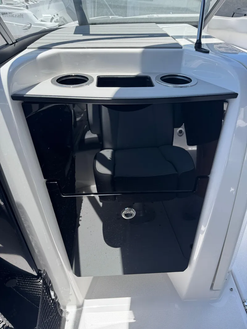 Slide: The Image of 2025 Yamaha Boats AR250 interior with cup holders and storage compartment. - 17