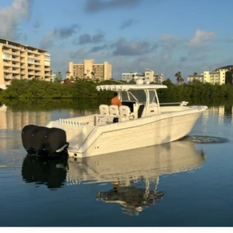 The Image of 2017 Stamas 390 Tarpon boat on calm water near buildings. - 0