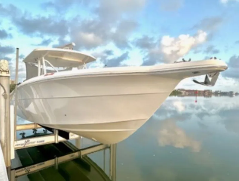 Slide: The Image of 2017 Stamas 390 Tarpon boat interior with seating and storage, docked by calm waters. - 11