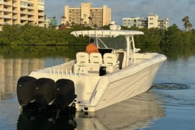 Slide: The Image of 2017 Stamas 390 Tarpon boat with triple engines cruising on calm water. - 2
