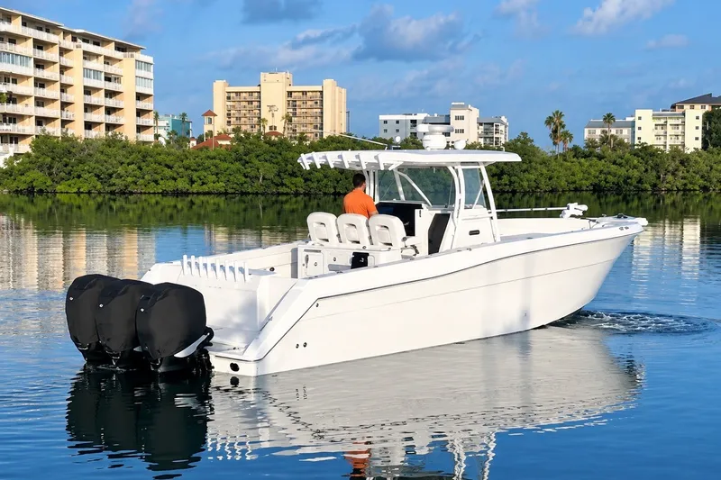The Image of 2017 Stamas 390 Tarpon boat cruising on calm water near coastal buildings. - 0