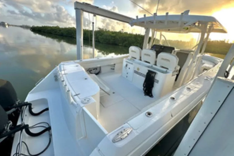 Slide: The Image of 2017 Stamas 390 Tarpon boat docked at sunrise, featuring spacious deck and seating. - 11