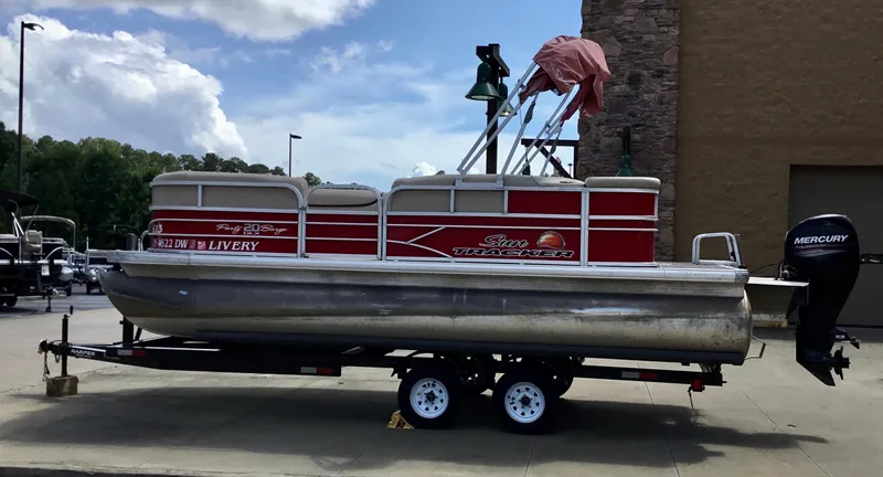 The Image of 2016 Sun Tracker Party Barge 20 DLX pontoon boat on trailer, outdoors. - 0