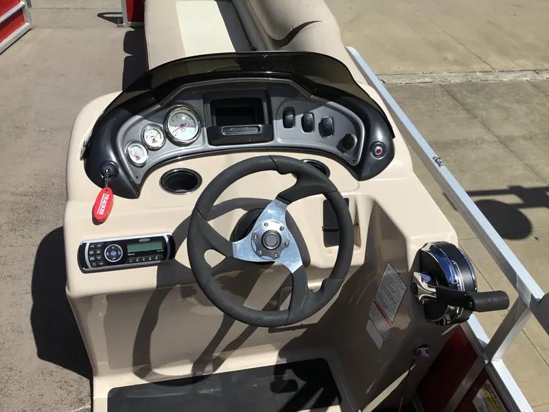 Slide: The Image of 2016 Sun Tracker Party Barge 20 DLX steering console with gauges and controls. - 3