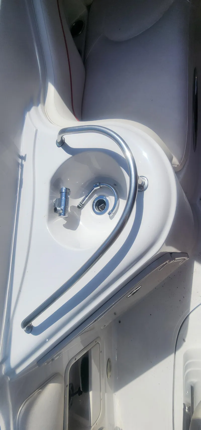 Slide: The Image of 2009 Crownline 250cr boat interior with a sleek sink and faucet design. - 11