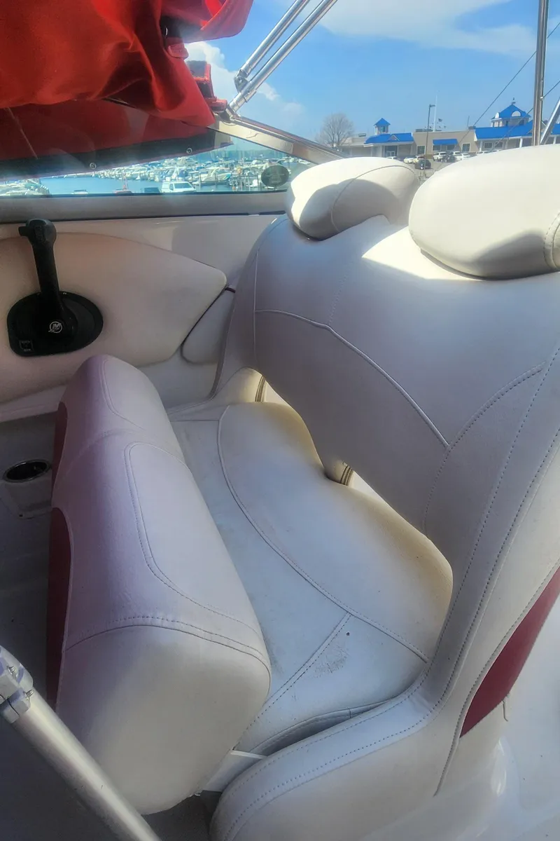 Slide: The Image of 2009 Crownline 250cr boat interior with white leather seating and red accents. - 14