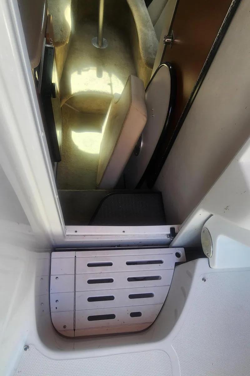 Slide: The Image of 2009 Crownline 250cr cabin interior with seating and step detail. - 15