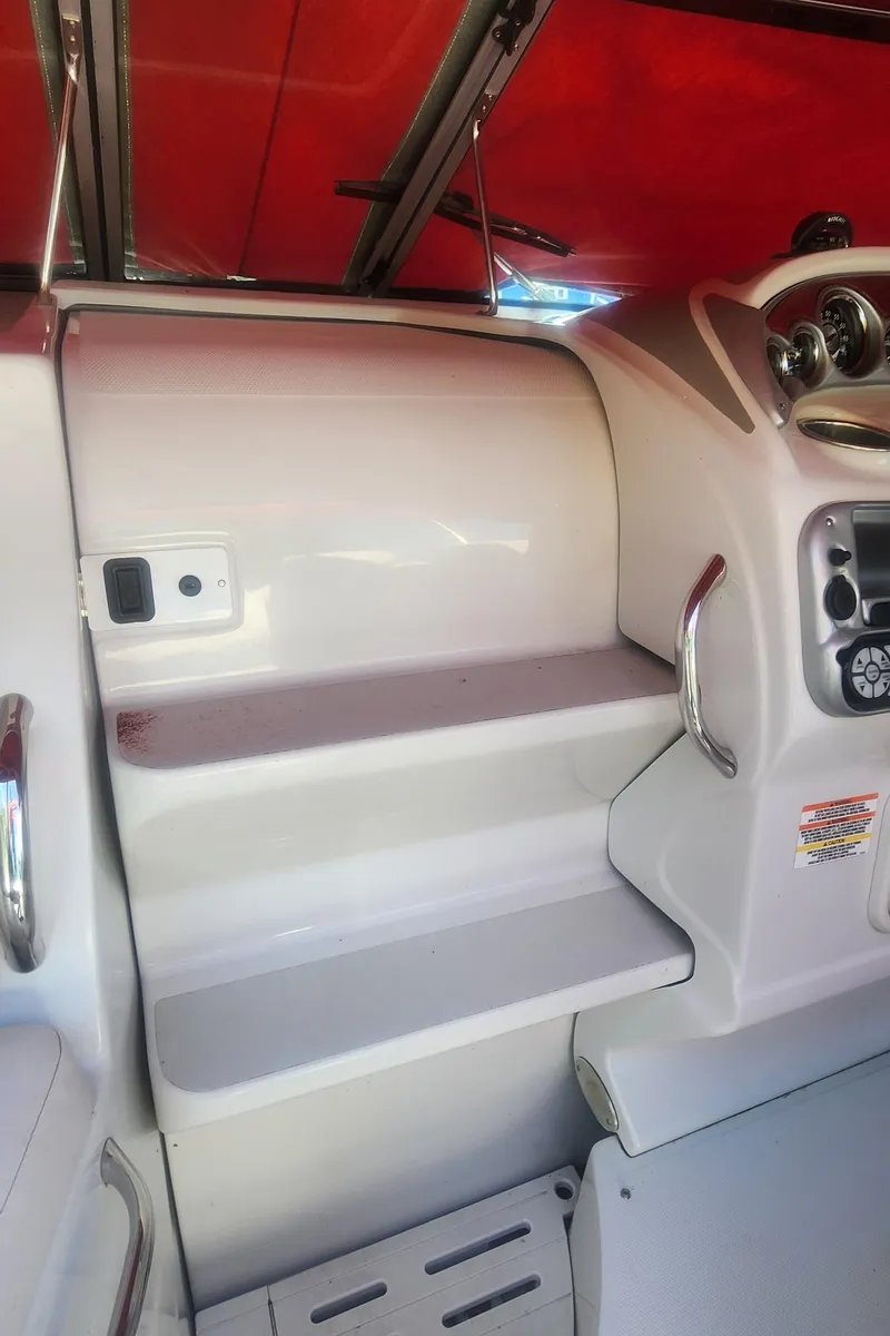 Slide: The Image of 2009 Crownline 250cr boat interior with red canopy and control panel. - 16