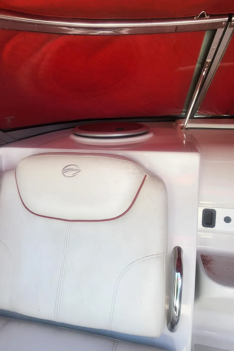 Slide: The Image of 2009 Crownline 250cr boat interior with white seating and red canopy. - 17