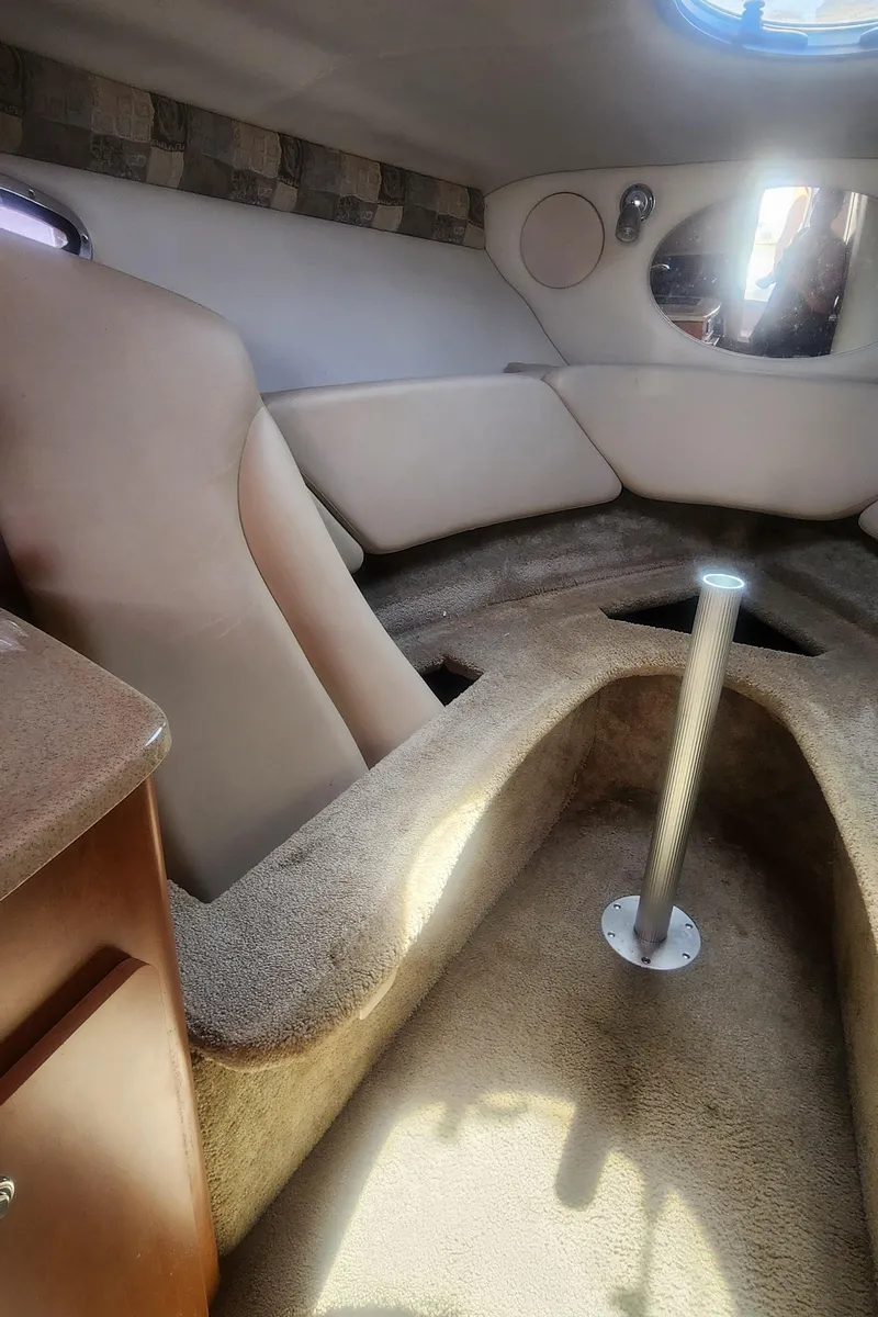 Slide: The Image of Interior of a 2009 Crownline 250cr boat cabin with seating and table mount. - 21