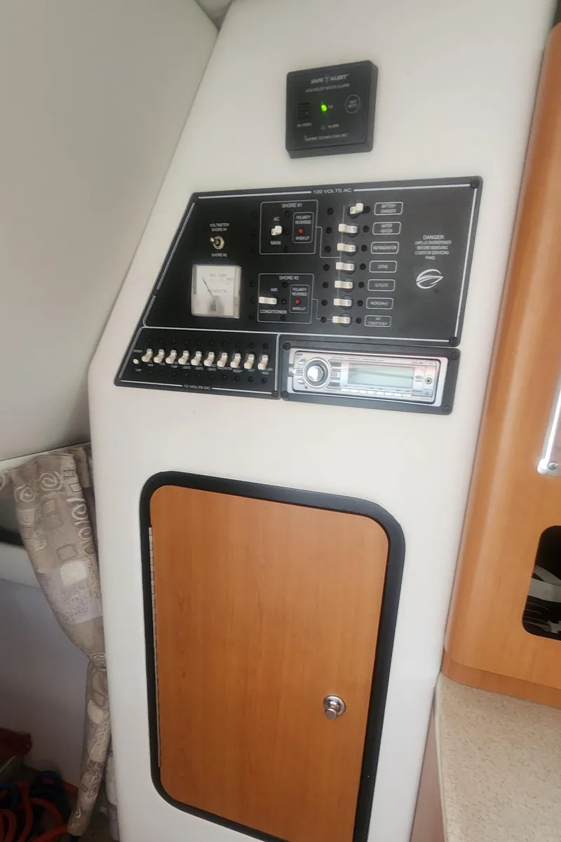 Slide: The Image of 2009 Crownline 250cr control panel with switches and gauges in cabin interior. - 24