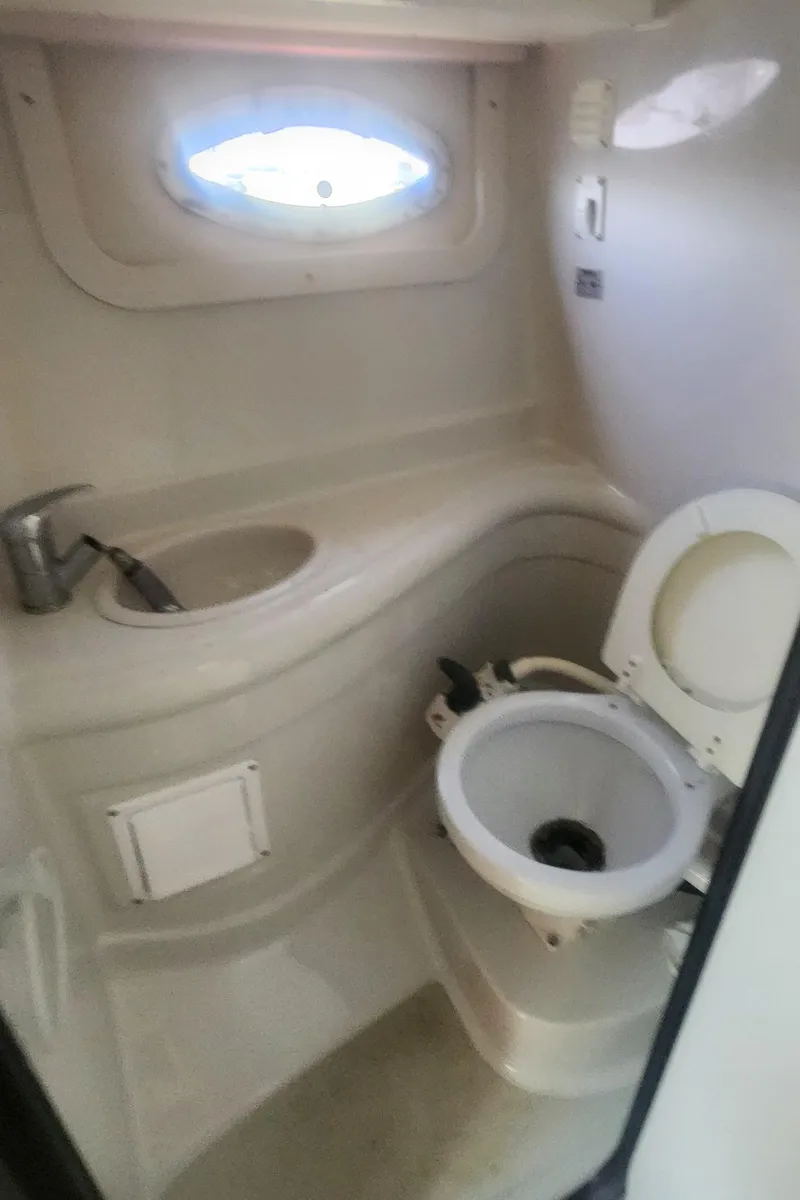 Slide: The Image of 2009 Crownline 250cr boat bathroom with sink and toilet. - 27