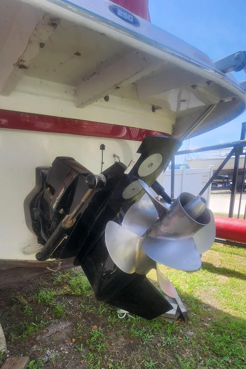 Slide: The Image of 2009 Crownline 250cr boat with dual propeller system, displayed on grass. - 32