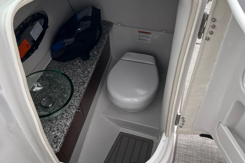 Slide: The Image of 2026 Crownline 270 SS boat bathroom with modern toilet and granite countertop. - 19