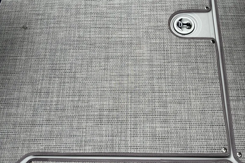 Slide: The Image of Gray textured surface with a circular latch, Crownline 270 SS 2026 boat detail. - 22