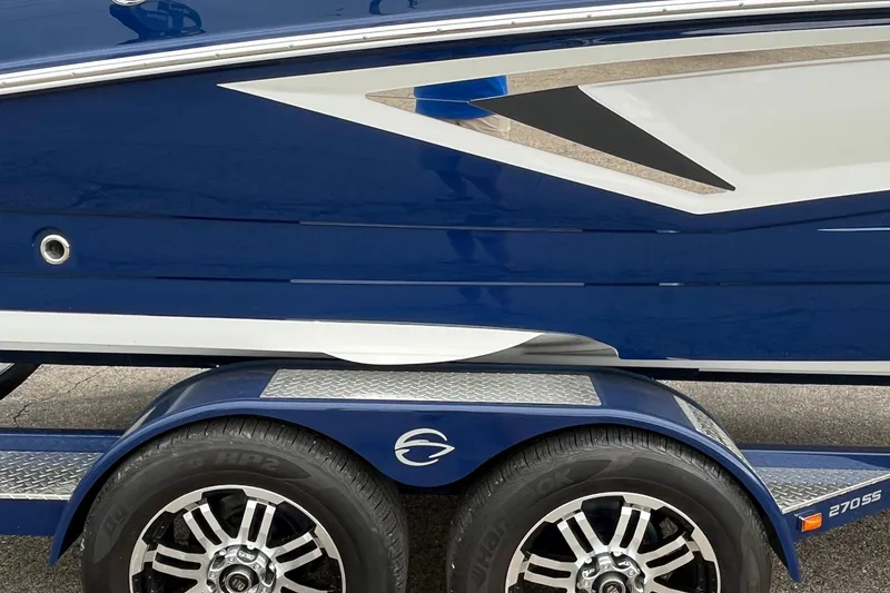Slide: The Image of 2026 Crownline 270 SS boat on trailer, featuring sleek blue and white design. - 25