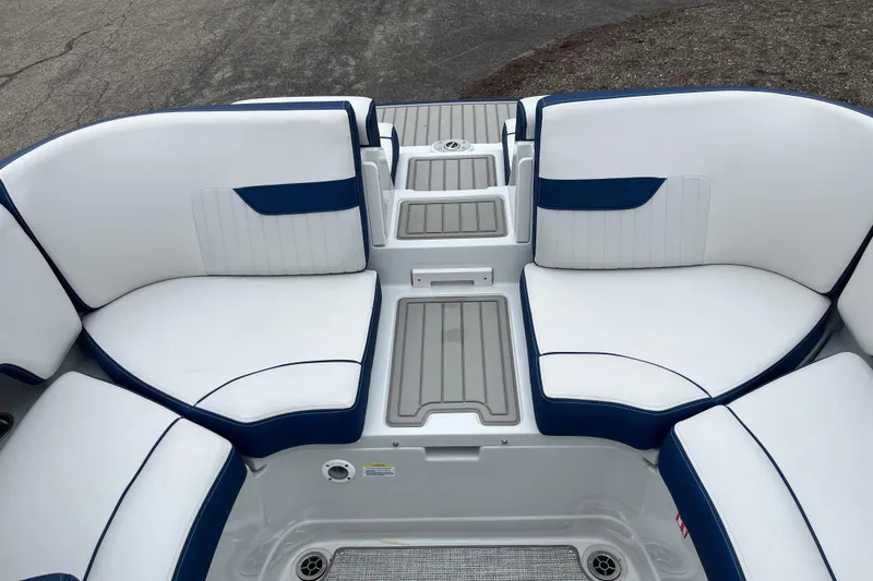 Slide: The Image of 2026 Crownline 270 SS boat interior with white and blue seating, featuring a central console. - 6