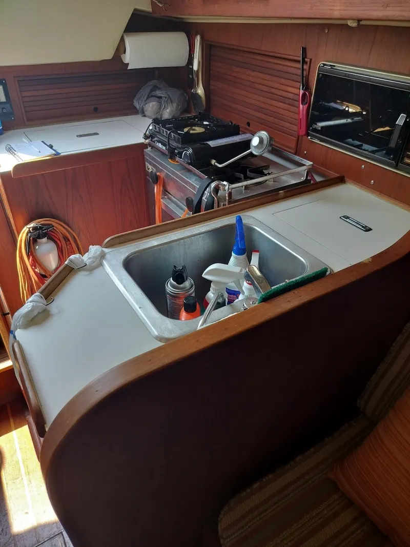 Slide: The Image of Interior of a 1983 Morgan 32-3 sailboat kitchen with sink and stove. - 11