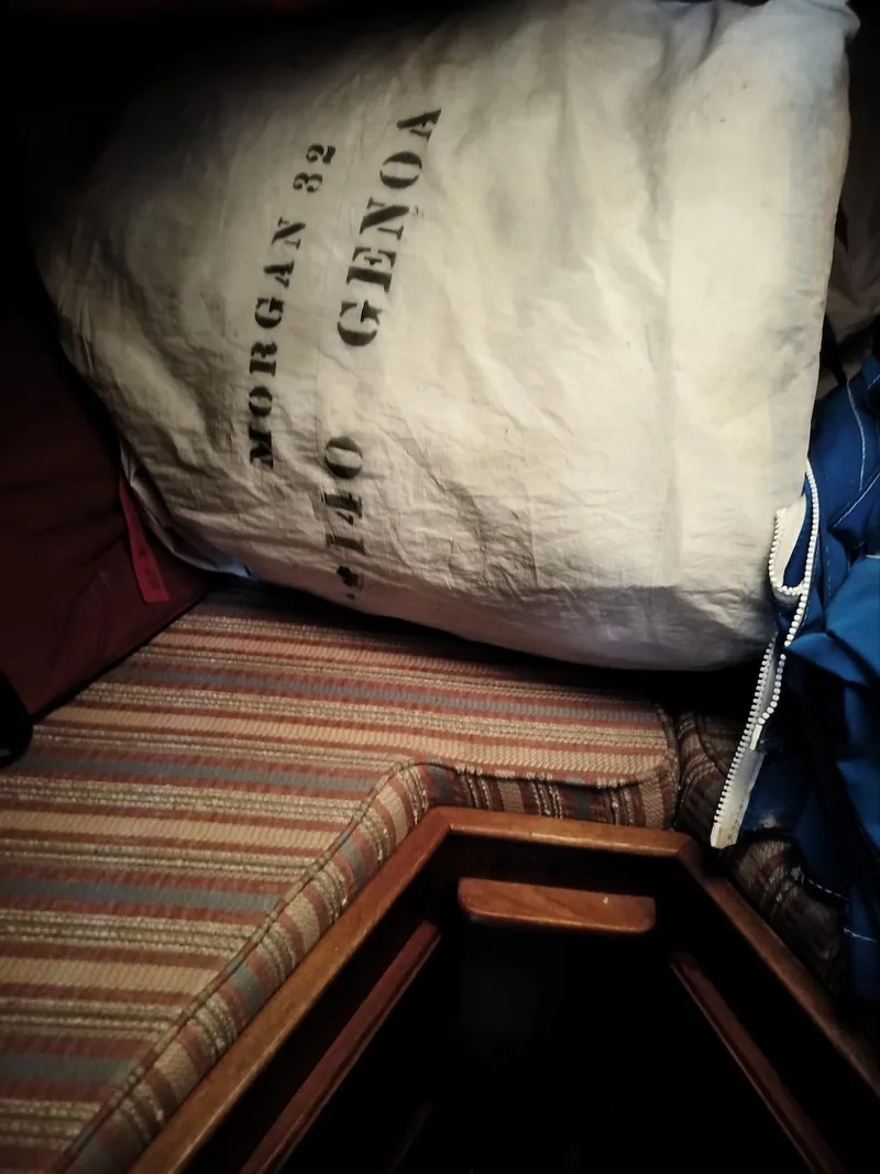 Slide: The Image of Sail bag labeled "Morgan 32 Genoa" on striped boat seat, 1983 model. - 2